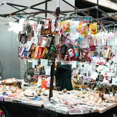 A vibrant market stall displaying a variety of cosmetics and makeup items for sale.